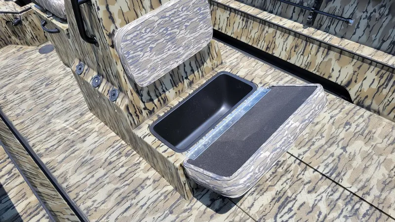 Slide: The Image of 2026 Smoker Craft Pro Sportsman 1872 CC boat with camo design and open storage compartment. - 14