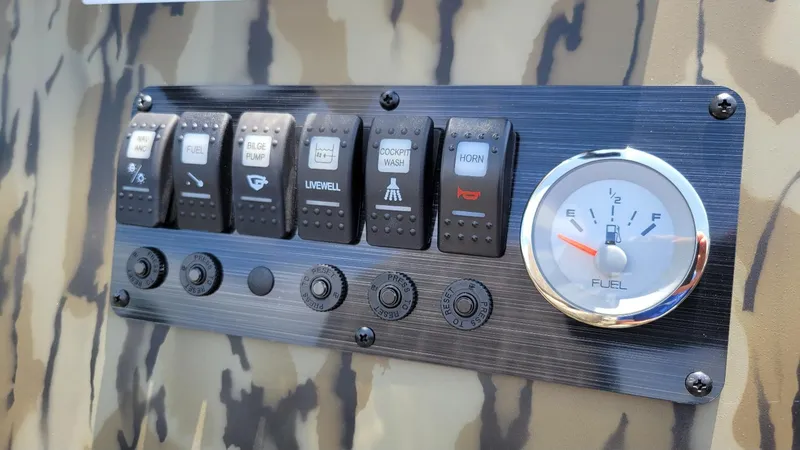 Slide: The Image of Control panel of 2026 Smoker Craft Pro Sportsman 1872 CC with fuel gauge and switches. - 17