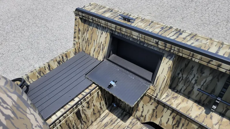 Slide: The Image of 2026 Smoker Craft Pro Sportsman 1872 CC boat interior with camo design and storage compartment. - 20