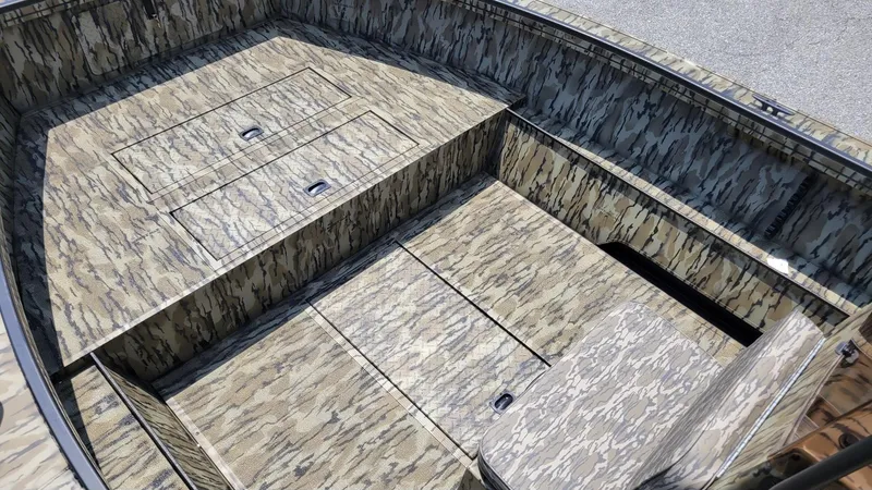 Slide: The Image of 2026 Smoker Craft Pro Sportsman 1872 CC center console boat with camouflage interior design. - 9