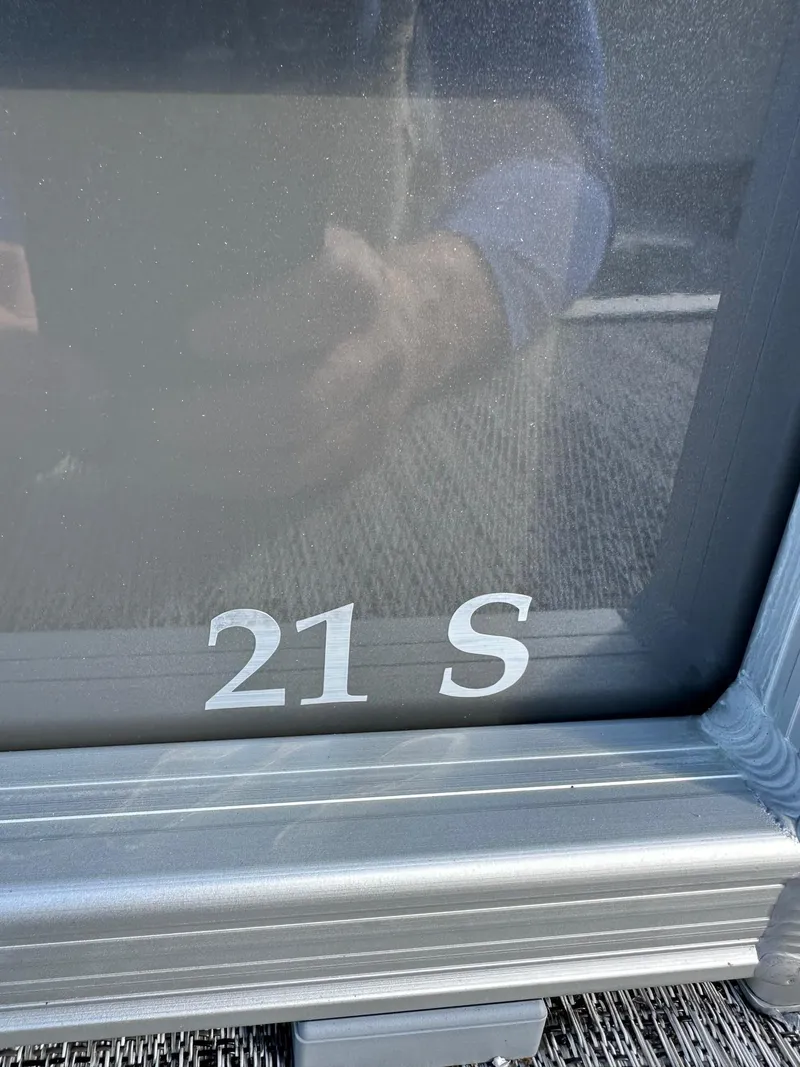 Slide: The Image of Close-up of Bennington 21 S model boat, 2025, with reflective surface. - 16