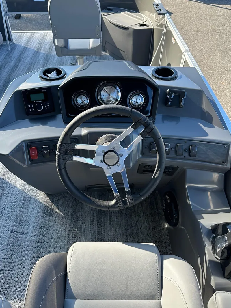 Slide: The Image of 2025 Bennington 21 SF Family boat dashboard with steering wheel and controls. - 22