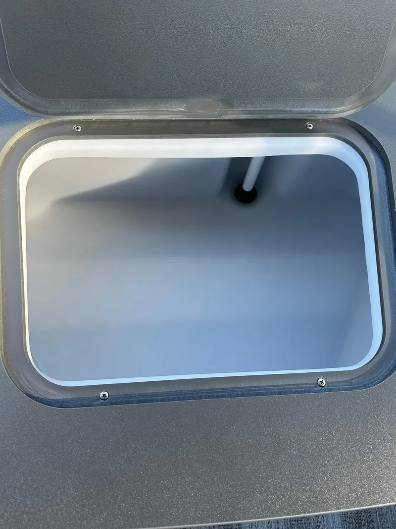 Slide: The Image of Open storage compartment on 2025 Bennington 21 SF Family boat. - 24
