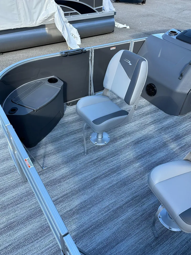 Slide: The Image of 2025 Bennington 21 SF Family boat interior with fishing seats and carpeted floor. - 3