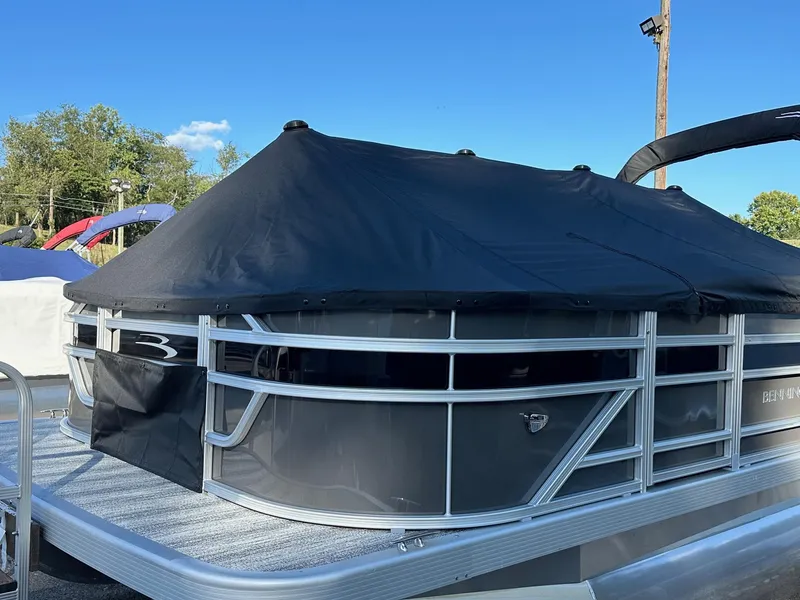 Slide: The Image of 2025 Bennington 21 SF pontoon boat with black cover, four fishing seats. - 32