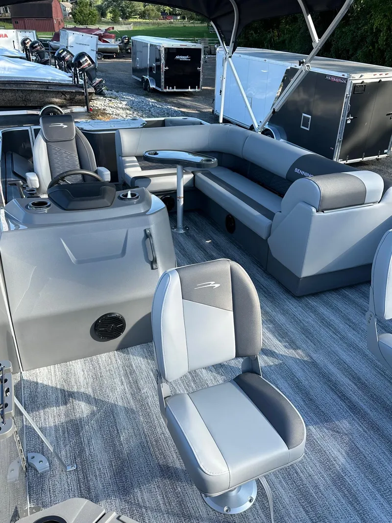Slide: The Image of 2025 Bennington 21 SF Family boat with four fishing seats, featuring sleek gray interior design. - 6