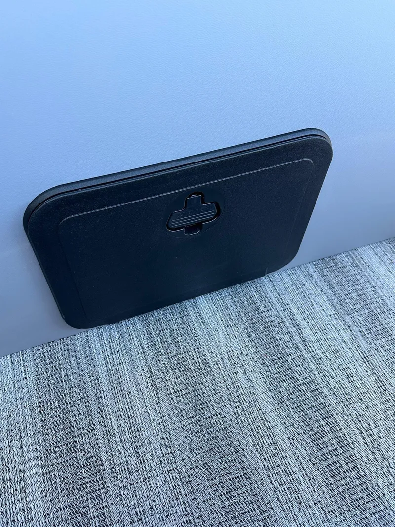 Slide: The Image of 2025 Bennington 21 SF Family boat storage compartment on textured flooring. - 9