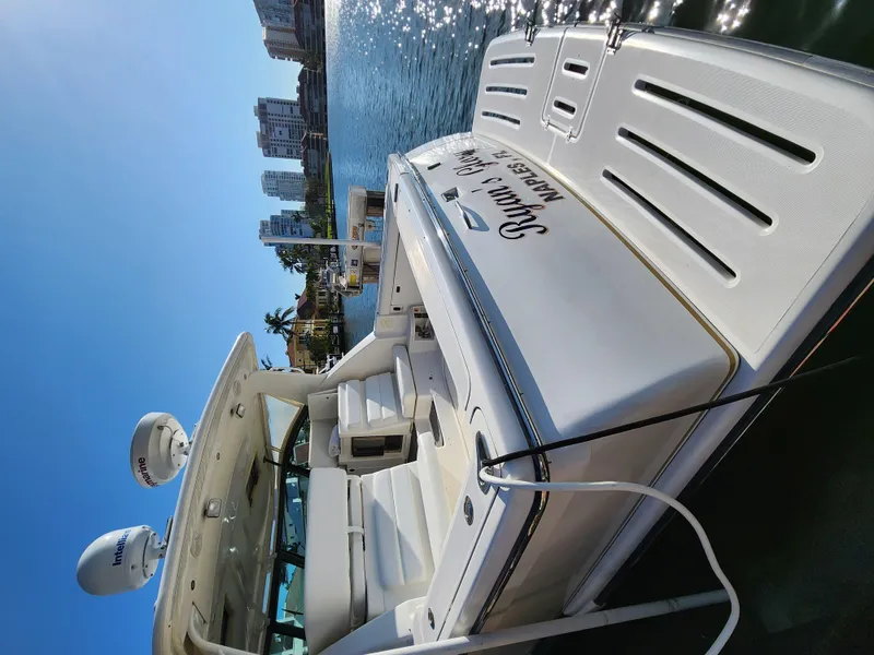 Slide: The Image of 2004 Tiara Yachts 38 Open docked, with cityscape and water reflections in the background. - 10