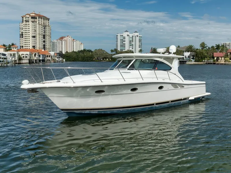 Slide: The Image of 2004 Tiara Yachts 38 Open cruising on a scenic waterway with city skyline backdrop. - 11