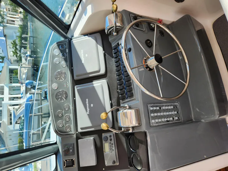 Slide: The Image of 2004 Tiara Yachts 38 Open helm with steering wheel and navigation instruments. - 16