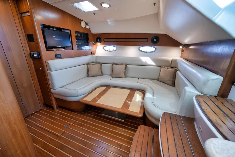 Slide: The Image of Luxurious interior of 2004 Tiara Yachts 38 Open with plush seating and wooden accents. - 2