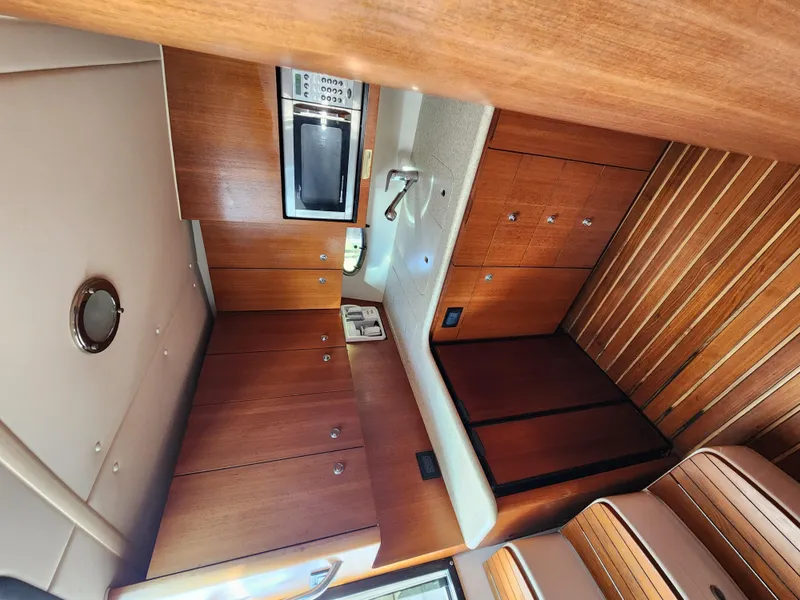 Slide: The Image of Interior of 2004 Tiara Yachts 38 Open, featuring wood cabinetry and modern appliances. - 20