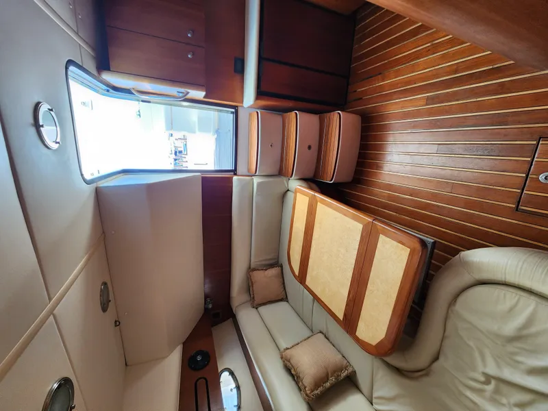 Slide: The Image of Interior of 2004 Tiara Yachts 38 Open, featuring wood flooring and comfortable seating. - 21