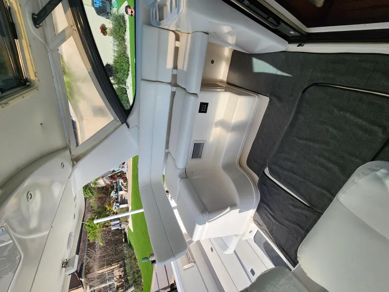 Slide: The Image of Interior of 2004 Tiara Yachts 38 Open, featuring white seating and carpeted flooring. - 24