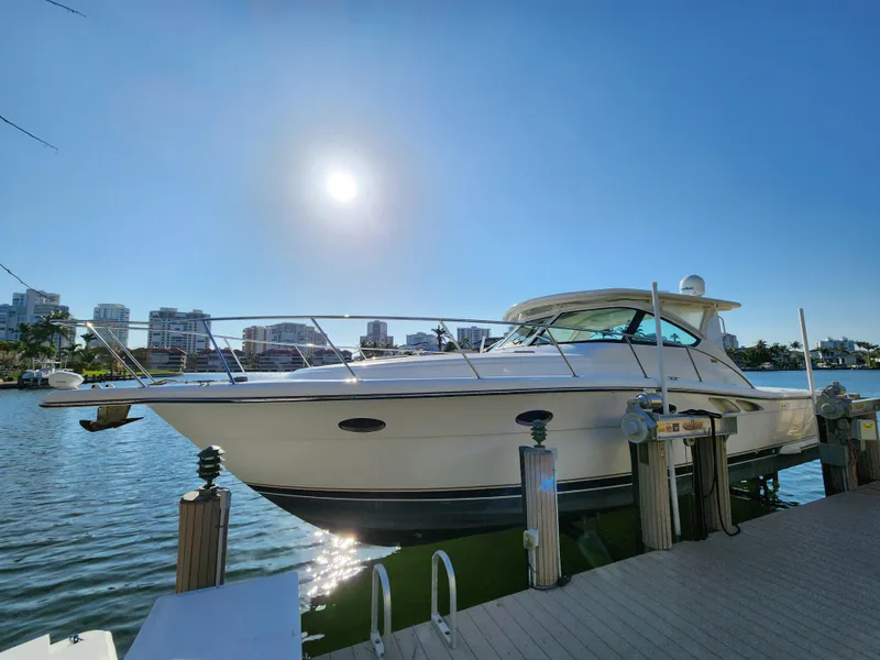Slide: The Image of 2004 Tiara Yachts 38 Open docked under clear blue sky. - 30