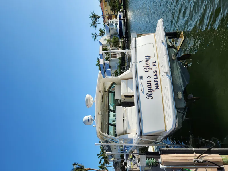Slide: The Image of 2004 Tiara Yachts 38 Open docked in Naples, Florida, under clear blue skies. - 31