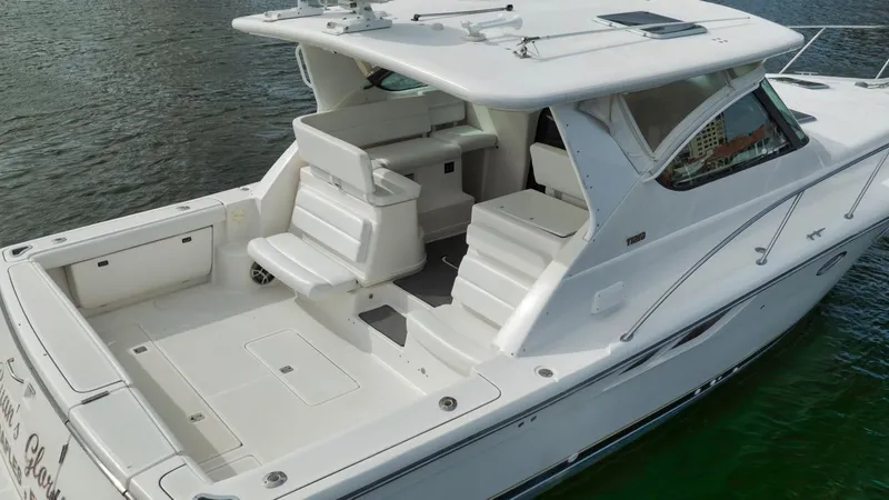 Slide: The Image of 2004 Tiara Yachts 38 Open, white exterior, spacious deck, docked on water. - 37