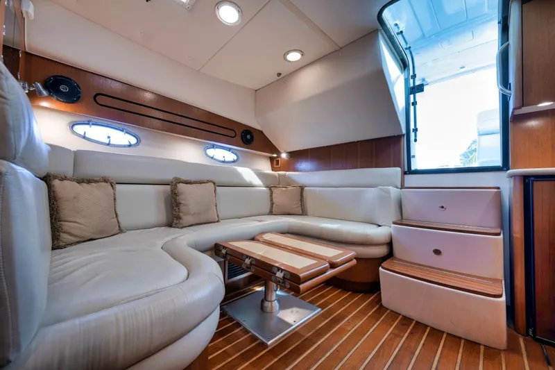 Slide: The Image of 2004 Tiara Yachts 38 Open interior with plush seating and wooden accents. - 46