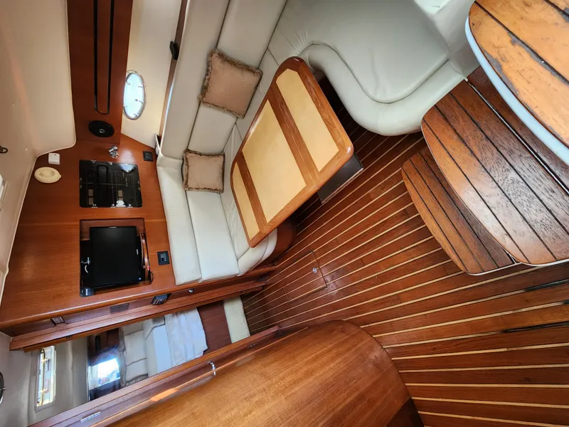 Slide: The Image of Interior of 2004 Tiara Yachts 38 Open, featuring wood flooring and comfortable seating. - 5