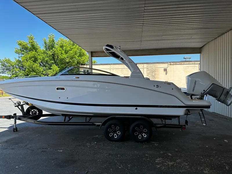 Slide: The Image of 2023 Four Winns HD8 OB boat on a trailer under a canopy. - 13
