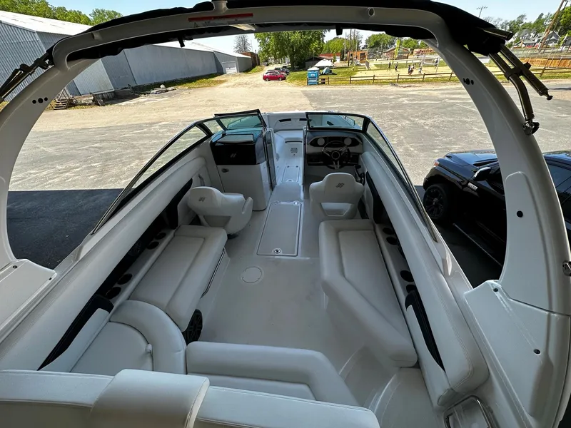 Slide: The Image of 2023 Four Winns HD8 OB boat interior with white seating and modern design. - 15