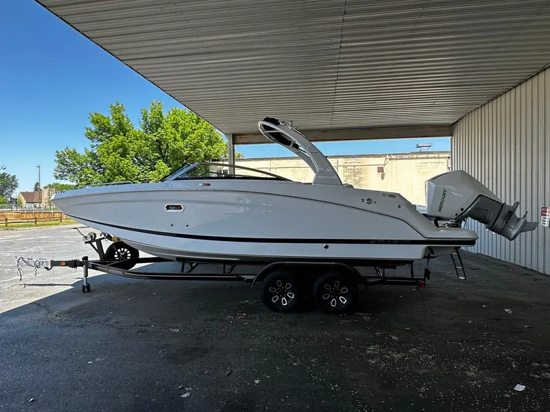 Slide: The Image of 2023 Four Winns HD8 OB boat on a trailer under a metal canopy. - 2