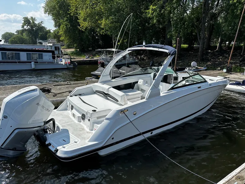Slide: The Image of 2023 Four Winns HD8 OB boat docked at a marina. - 24