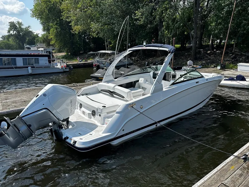 Slide: The Image of 2023 Four Winns HD8 OB boat docked at a marina. - 6