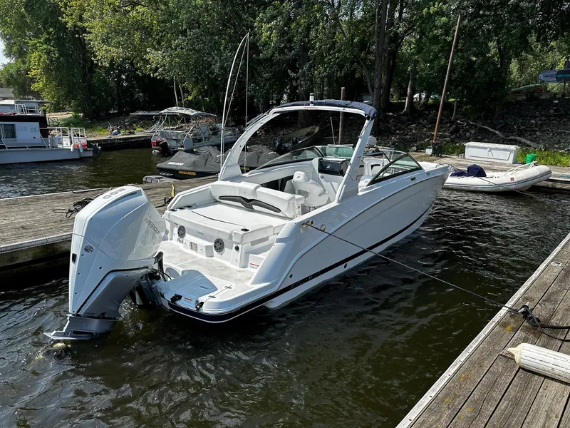 Slide: The Image of 2023 Four Winns HD8 OB boat docked in a marina. - 7