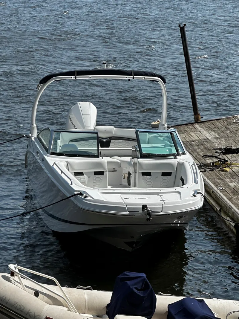 Slide: The Image of 2023 Four Winns HD8 OB boat docked on the water. - 8