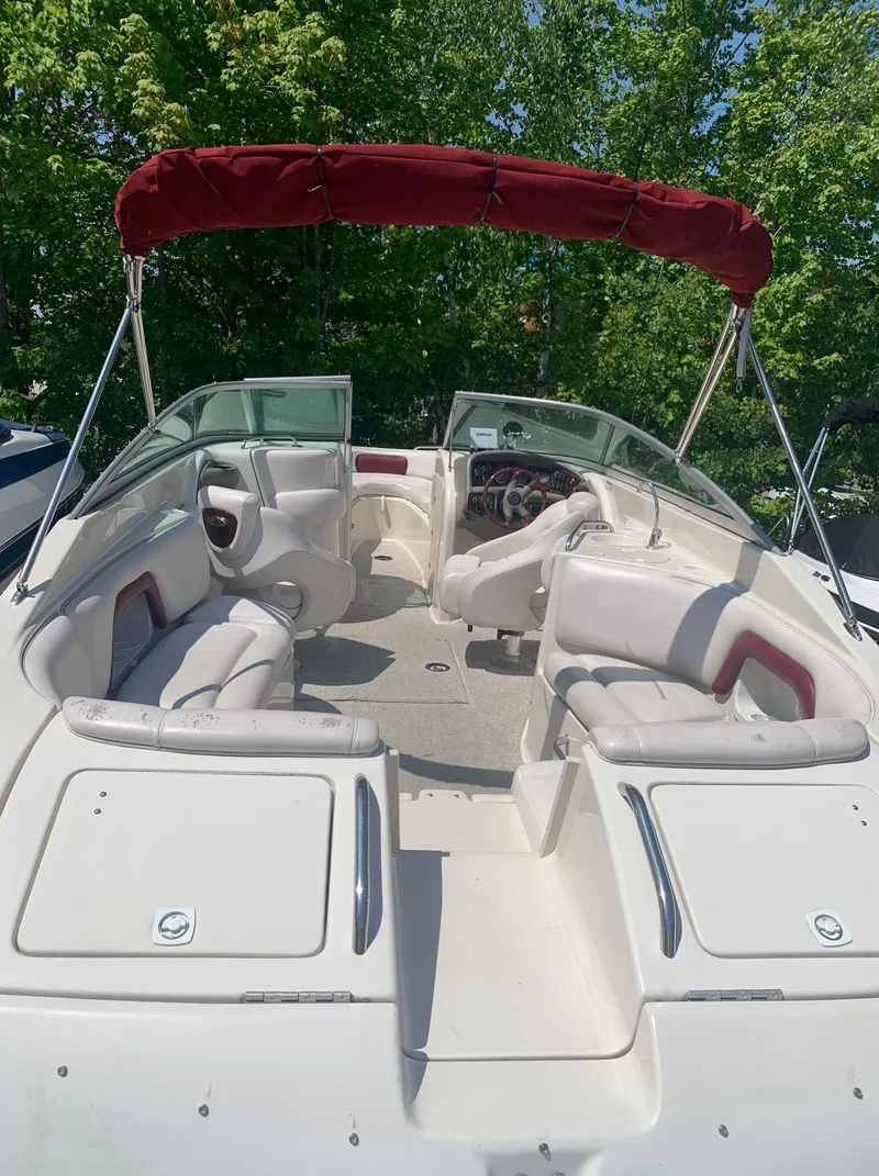 Slide: The Image of 2004 Crownline 270 BR boat with red canopy and white interior. - 11