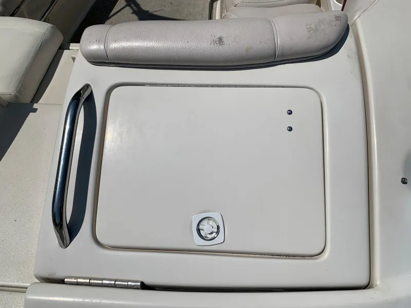 Slide: The Image of 2004 Crownline 270 BR boat storage compartment with handle and cushion. - 16