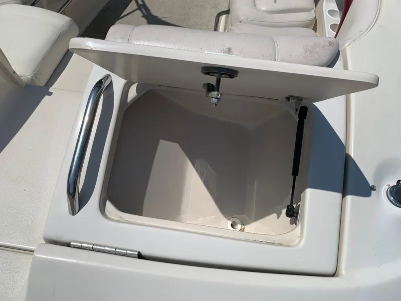 Slide: The Image of Open storage compartment on a 2004 Crownline 270 BR boat. - 17