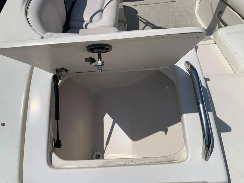 Slide: The Image of Open storage compartment on a 2004 Crownline 270 BR boat. - 18