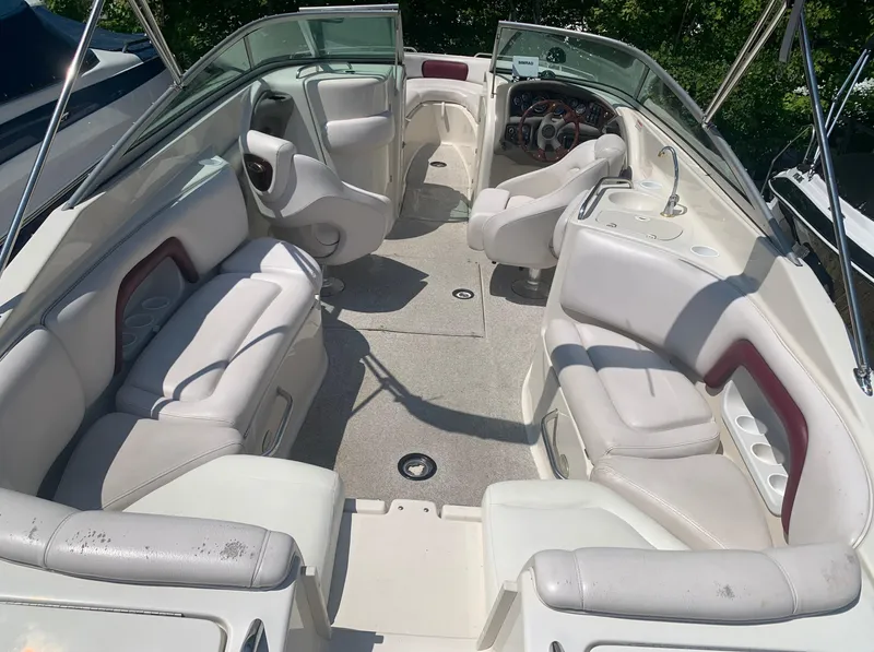Slide: The Image of 2004 Crownline 270 BR boat interior with white seating and spacious layout. - 19