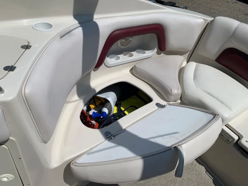 Slide: The Image of 2004 Crownline 270 BR boat interior storage compartment with open hatch. - 25
