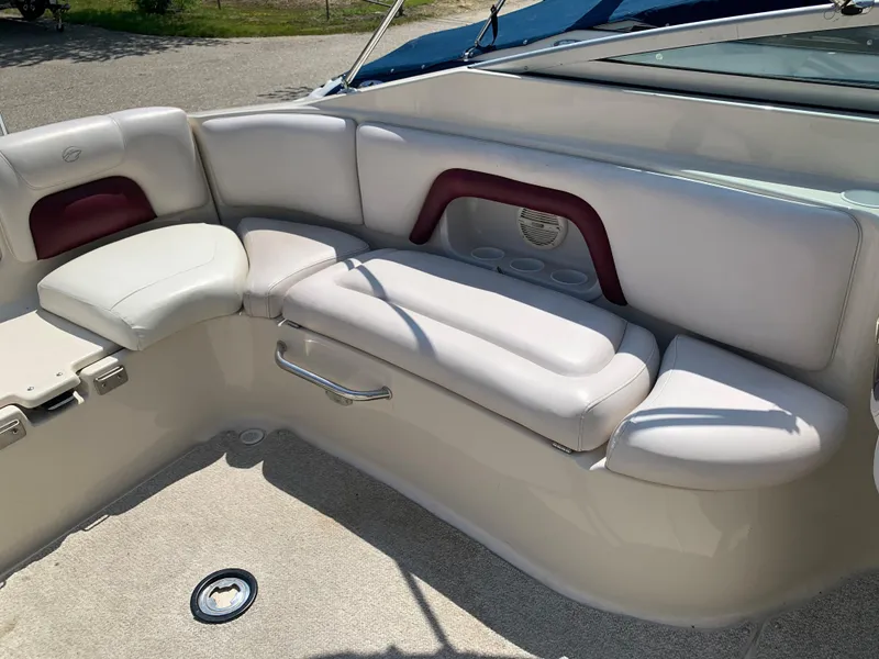 Slide: The Image of 2004 Crownline 270 BR boat interior with white and maroon seating. - 26