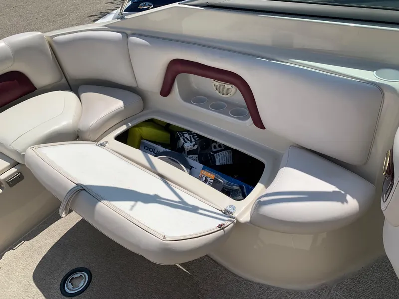 Slide: The Image of 2004 Crownline 270 BR boat with open storage compartment and seating. - 27