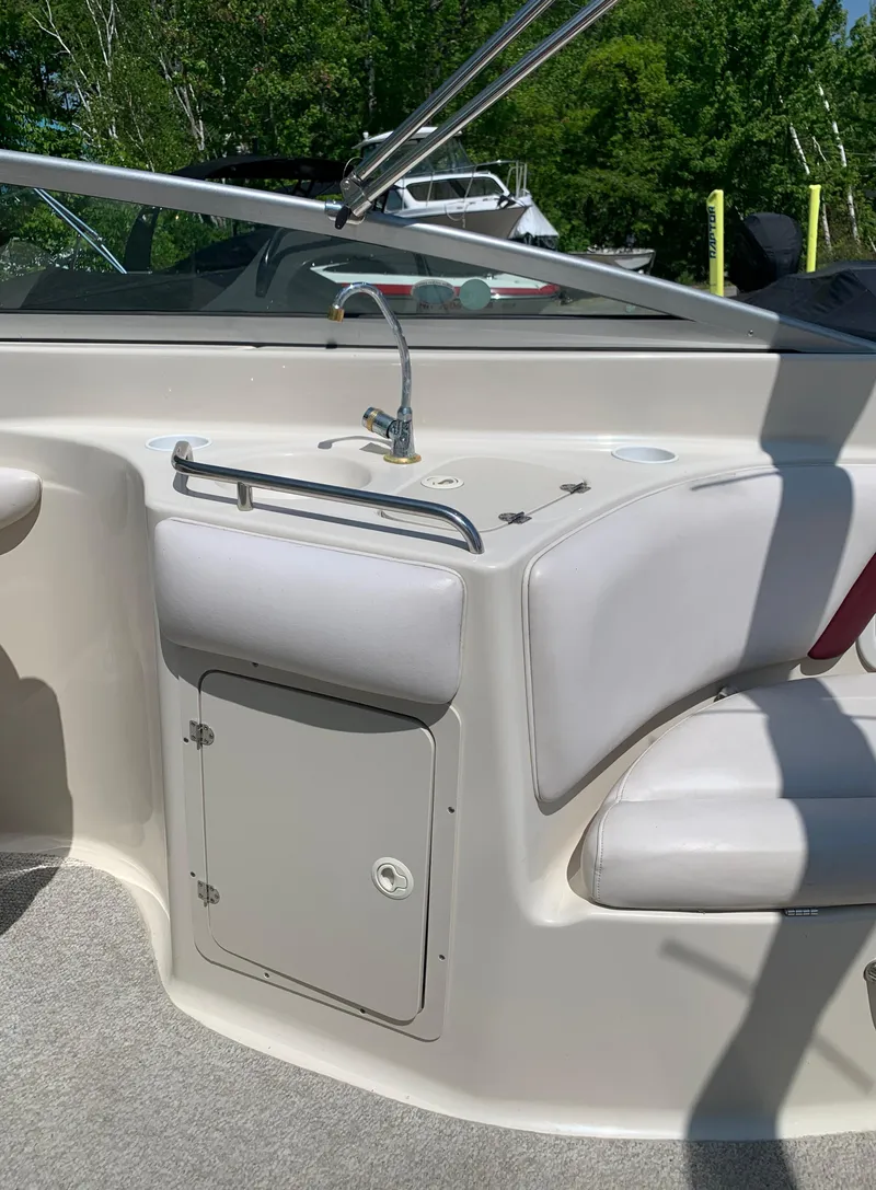 Slide: The Image of 2004 Crownline 270 BR boat interior with sink and seating. - 28