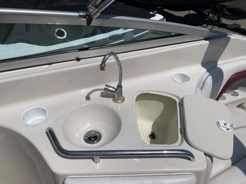 Slide: The Image of 2004 Crownline 270 BR boat sink and storage compartment. - 30