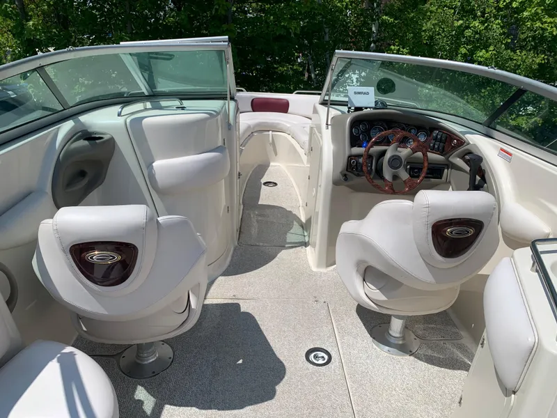 Slide: The Image of 2004 Crownline 270 BR boat interior with white seating and steering console. - 35