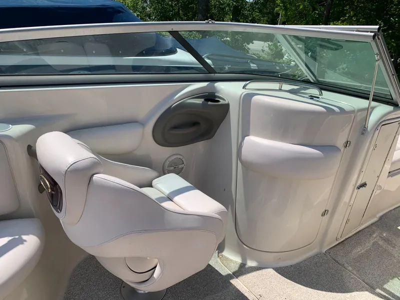 Slide: The Image of 2004 Crownline 270 BR boat interior with white seating and windshield. - 36