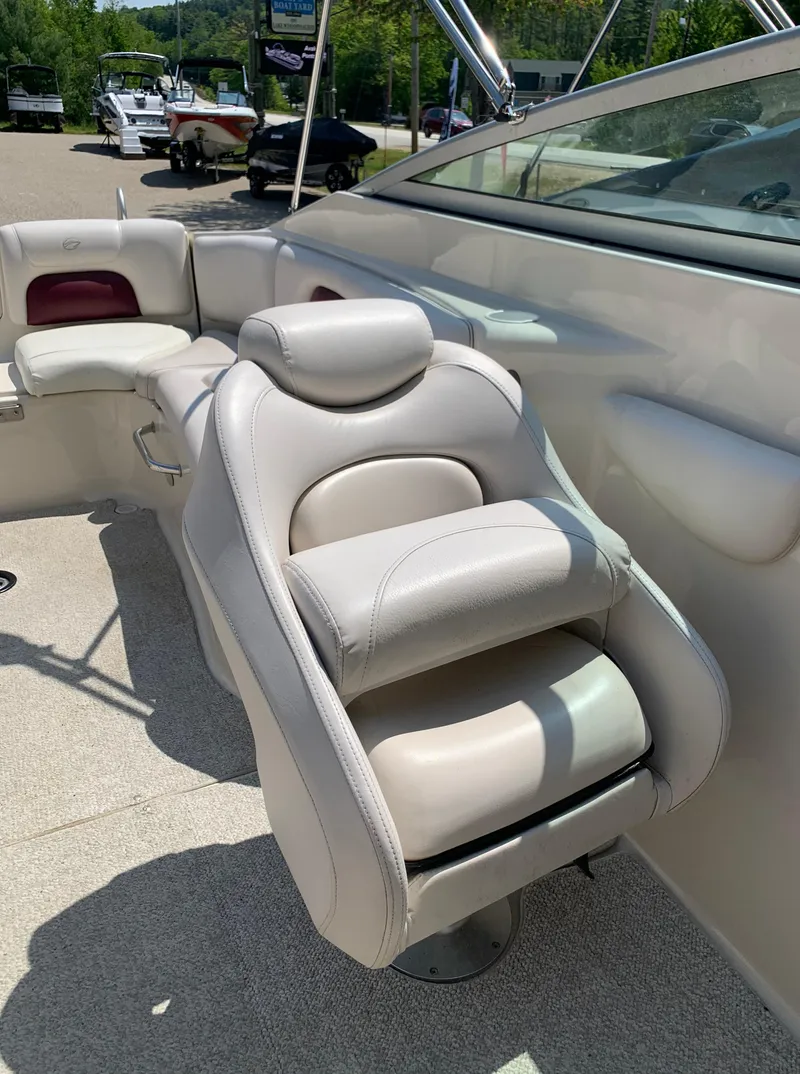 Slide: The Image of 2004 Crownline 270 BR boat interior with white leather seating. - 38