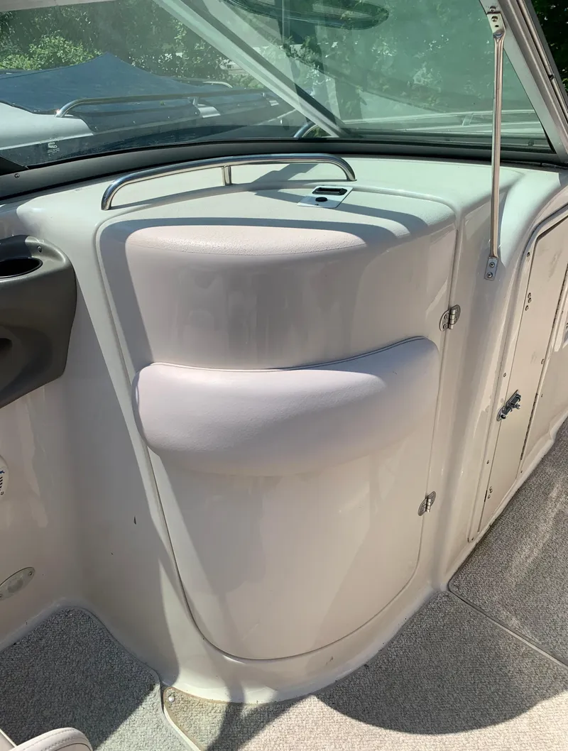 Slide: The Image of 2004 Crownline 270 BR boat interior with storage compartments and seating. - 39