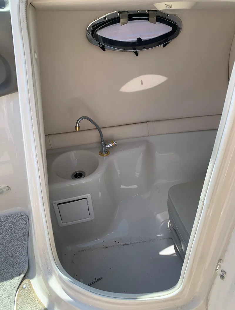 Slide: The Image of 2004 Crownline 270 BR boat interior bathroom with sink and porthole. - 41