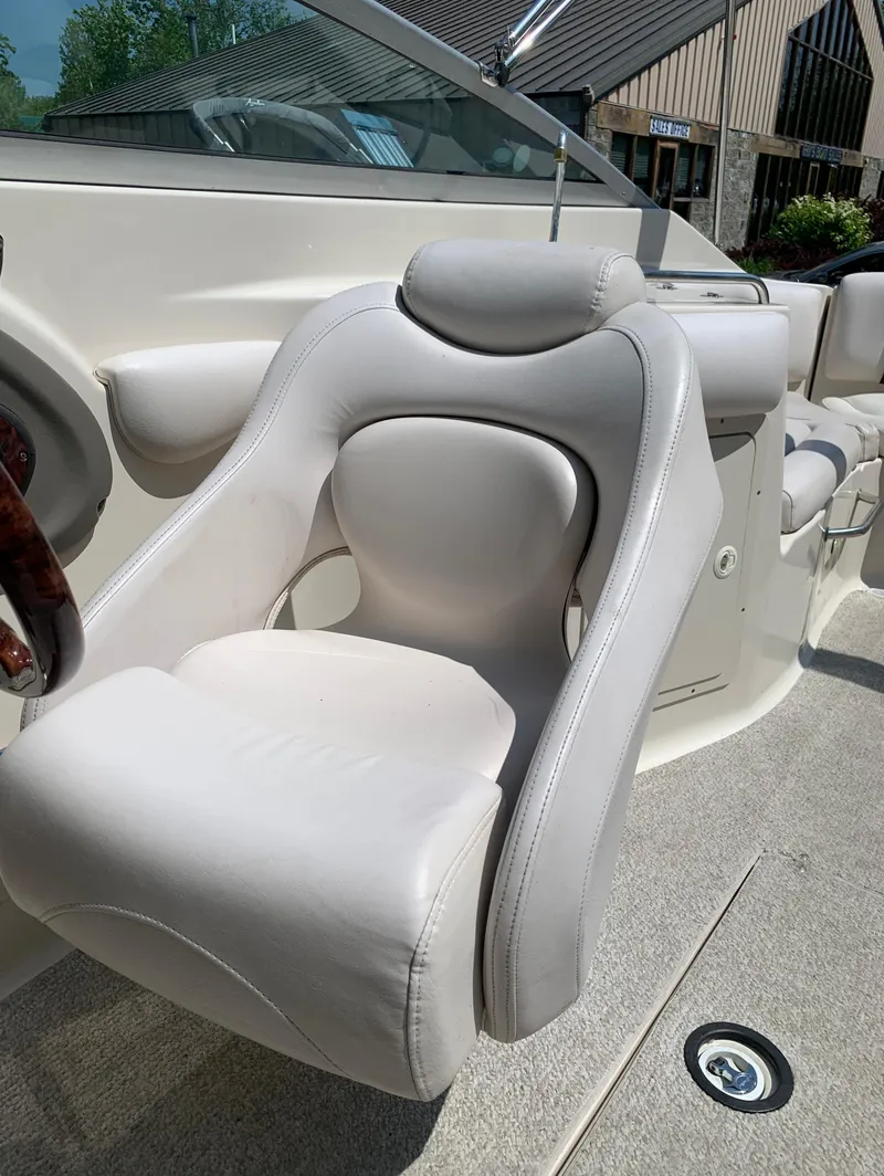 Slide: The Image of Captain's chair on a 2004 Crownline 270 BR boat, featuring white upholstery. - 48