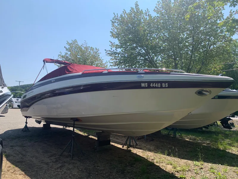 Slide: The Image of 2004 Crownline 270 BR boat with red cover on land. - 5