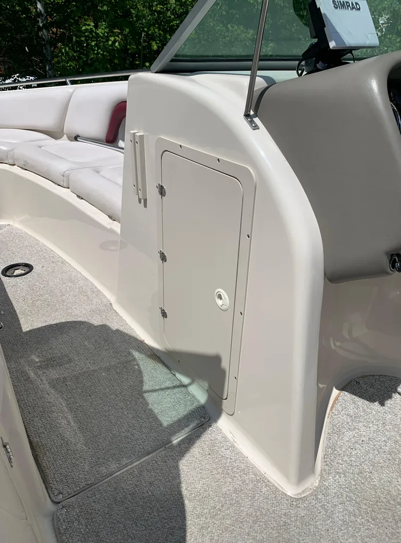 Slide: The Image of 2004 Crownline 270 BR boat interior with seating and storage compartment. - 50