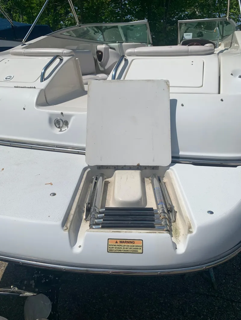 Slide: The Image of 2004 Crownline 270 BR boat with open storage compartment. - 8