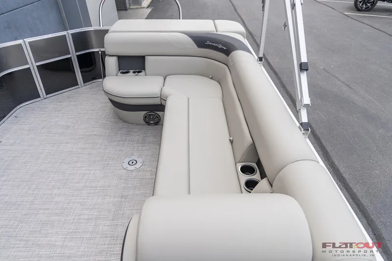 Slide: The Image of 2023 South Bay L-Lounge Tri-Toon 150HP boat interior with plush seating and cup holders. - 10